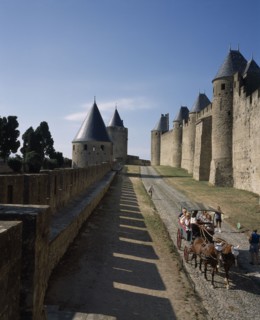 FRANCE, Languedoc Roussillon, Aude, Carcassone. La Cite inner and outer ramparts with hourse drawn