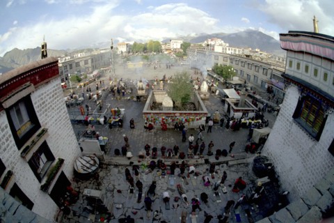CHINA, Tibet, Lhasa, Wide angle view from the rooftop of the Jokhang Temple over people lying