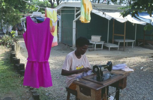 JAMAICA, Ocho Rios, Dressmaker working outside at hand operated sewing machine.