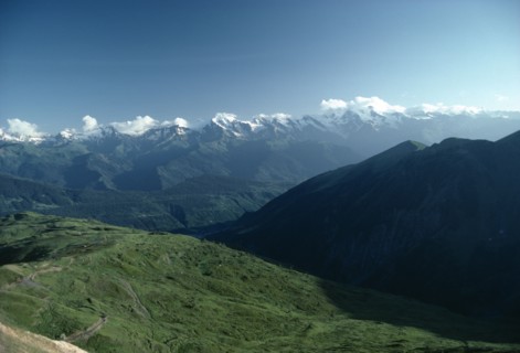 GEORGIA, Caucusas Mountains, Mountain landscape with distant snow covered peaks and dense forest on