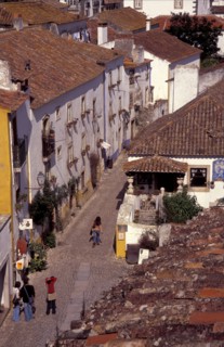 PORTUGAL, Leiria, Obidos, General view over cobbled street and rooftops