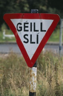 IRELAND, Donegal, Inishowen, Road sign in Gaelic.