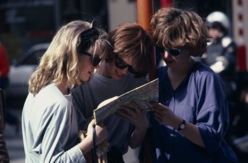 BELGIUM, Brussels, Three female tourists reading a map outside the Grand Palace