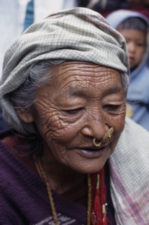 NEPAL, East, Dhankuta Region, Elderly Limbuni tribeswoman wearing traditional gold Limbu nose