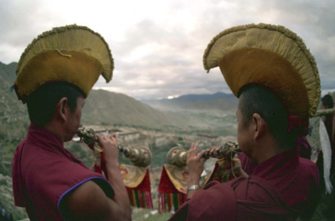 CHINA, Tibet, Drepung Monastery, Two monks blowing spiritual horns