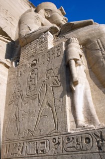 EGYPT, Nile Valley, Abu Simbel, Sun Temple of Ramses II.  Part view of one of the colossi of Ramses