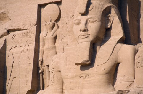 EGYPT, Nile Valley, Abu Simbel, Sun Temple of Ramses II.  Part view of colossi of Ramses II and