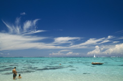 PACIFIC ISLANDS, Polynesia, Society Islands, Moorea.  Beach and tourist sunbathers and swimmers.