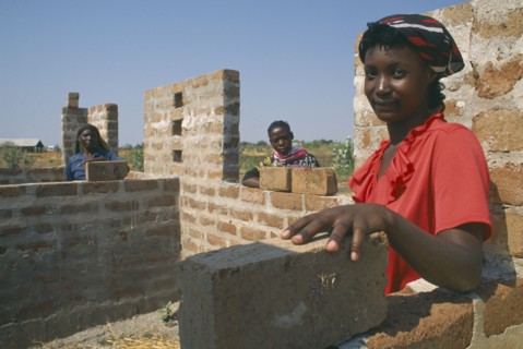 TANZANIA, Shinyanga, Mshikimano squatter settlement. Isabella Humbidi at site of new low cost house