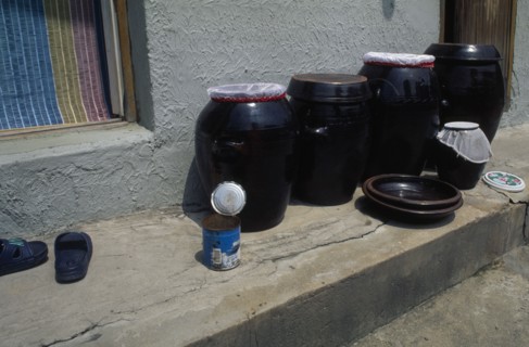 SOUTH KOREA, Sokcho, Ceramic jars of kimchi traditional pickled vegetables standing on doorstep of