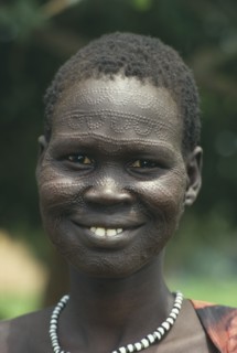 SUDAN, South, Portrait of a smiling Neuer girl with facial scarification