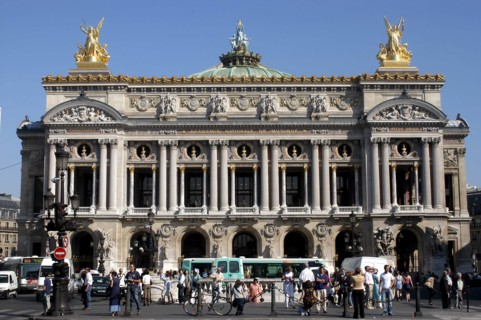 FRANCE, Ile de France, Paris, The Opera Garnier columned facade with golden statues a top and crowd