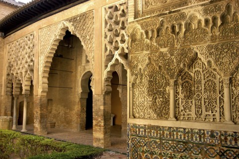SPAIN, Andalucia, Seville, The Royal Alcazar interior courtyard view of decorative archway