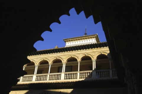SPAIN, Andalucia, Seville, The Royal Alcazar. Angled view looking up at the roof through an archway