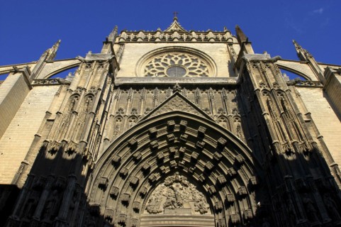 SPAIN, Andalucia, Seville, Angled view looking up at the Puerta de la Asuncion gothic style portal