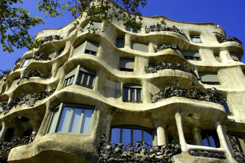 SPAIN, Catalonia, Barcelona, Angled view looking up at Gaudi apartment building Casa Mila