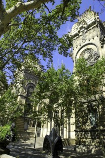 SPAIN, Catalonia, Barcelona, Angled view of the Barcelona Museum facade seen through trees