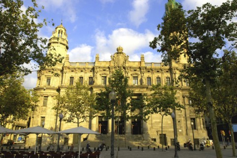 SPAIN, Catalonia, Barcelona, Telephone building facade with cafe in the square in front