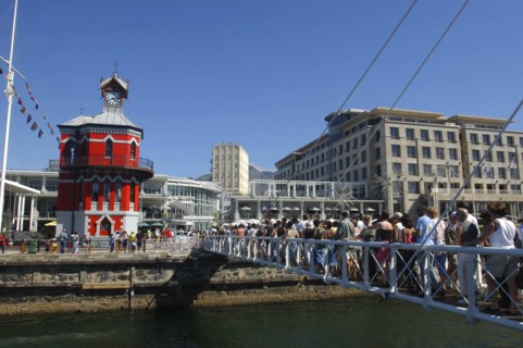 SOUTH AFRICA, Western Cape, Cape Town, Waterfront with queue of people on a bridge crossing over to