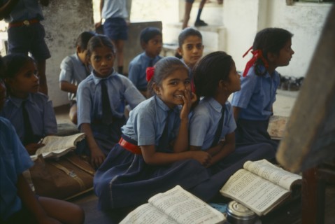 INDIA, Rajasthan, Sisarma Village, Pupils in uniform in classroom of village school.