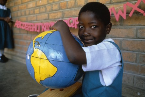 MALAWI, Blantyre, Schoolgirl with papier mache globe teaching aid made by PAMET who recycle
