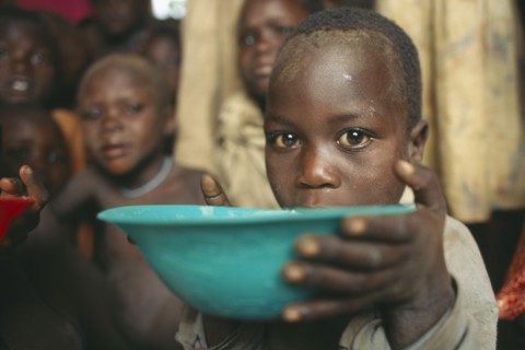 UGANDA, Moroto, Karamoja.  Feeding project for vulnerable people.  Child receiving bowl.