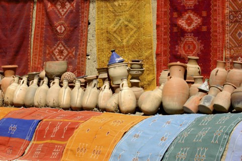 MOROCCO, Marrakech, Display of colourful cloths and ceramics for sale