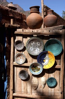 MOROCCO, Marrakech, Display of ceramic plates and vases on a wooden cabin door