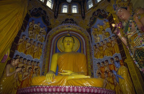SRI LANKA, Colombo, Statue of seated Buddha in ornate Buddhist temple