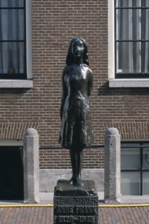 HOLLAND, Noord, Amsterdam, Westermarkt. Statue of Anne Frank the young diary writer during the Nazi