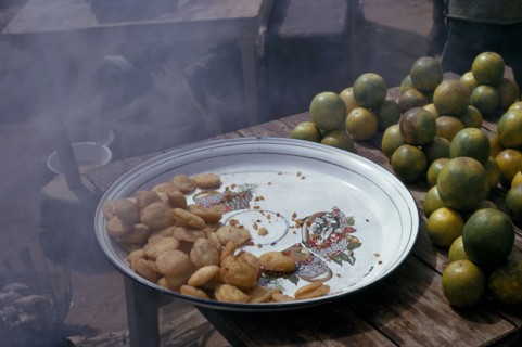 NIGERIA, Jos, Deep fried pea cakes and green oranges.