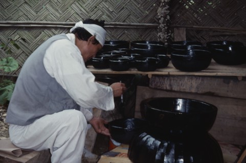 SOUTH KOREA, Crafts, Korean Folk Village.  Man lacquering wooden bowls.