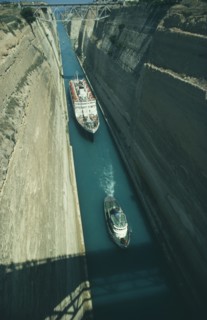 GREECE, Peloponese, Corinth Canal, Cruise ship being towed by a tug through the canal