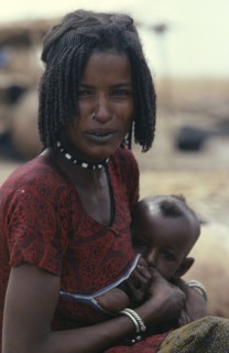 NIGERIA, North, Shua Arab woman breast feeding her child wearing a special breast feeding dress