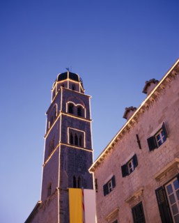CROATIA, Dalmatia, Dubrovnik, Angled view looking up at the Francisan Monastery tower illuminated