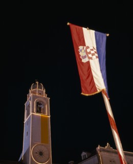 CROATIA, Dalmatia, Dubrovnik, View looking up at the Clocktower illuminated at night with Croatian