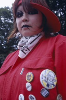 JAPAN, Honshu, Tokyo, Harajuku District. Portrait of young teenage girl wearing a red jacket and