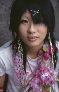 JAPAN, Honshu, Tokyo, Harajuku District. Portrait of a teenage girl wearing a flower garland and