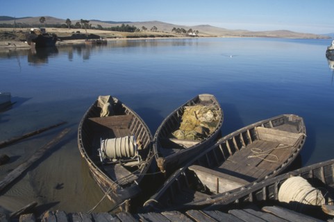 RUSSIA, Siberia, Lake Baikal, Wooden fishing boats moored beside wooden jetty.