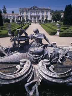 PORTUGAL, Near Lisbon, Palacio Nacional de Queluz facade with fountain statue in the foreground and