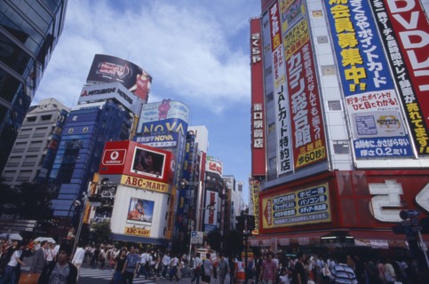 JAPAN, Honshu, Tokyo, Shinjuku. View of advertisement covered architecture in busy city street
