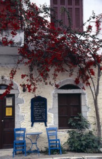 GREECE, Peloponnese, Mani Peninsula, Kardamili. Taverna exterior with blue table and chairs on
