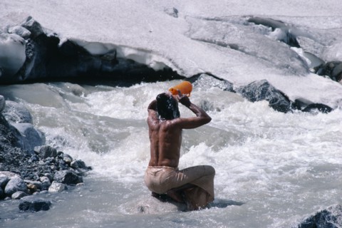 INDIA, Uttar Pradesh, Garhwal Region, Pilgrim bathing in snow melted water at Gormuich the Cows