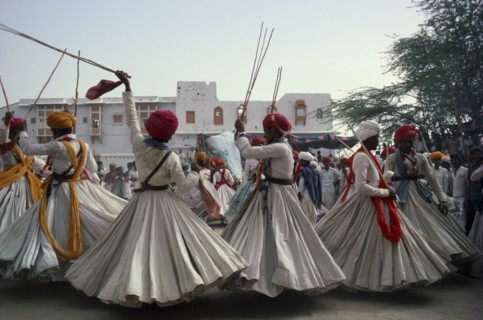 INDIA, Rajasthan, Jodhpur, Men in traditional clothes performing dance for the Maharaja of Jodhpur