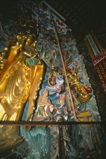 CHINA, Yunnan, Kunming, Golden statuary inside Huating Temple.