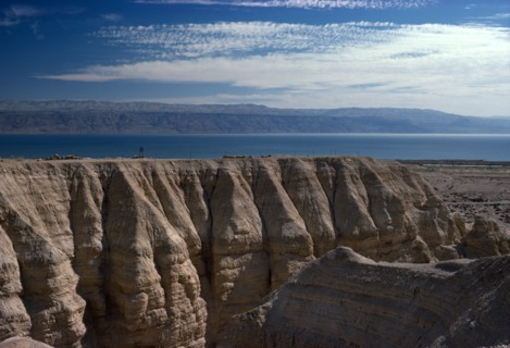 ISRAEL, Quamran, View over rocky eroded cliffs to the Dead Sea beyond