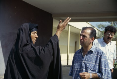 IRAQ, Amara, Marsh Arab woman talking and demonstrating with a hand gesture to a Oxfam engineer.