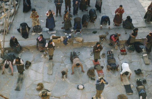 TIBET, Lhasa, Jokhang Monastery, Pilgrims prostrate themselves and pray in front of Jokhang