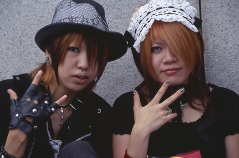 JAPAN, Honshu, Tokyo, Harajuku District. Portrait of two girls dressed in teenage Japanese style