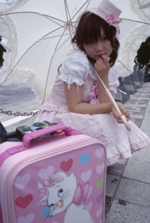 JAPAN, Honshu, Tokyo, Harajuku District. Portrait of young teenage girl wearing a pink and white